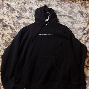 We’re not really strangers Black Hoodie with Embroidered Text